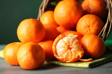 Fresh ripe mandarins in wicker basket, close-up