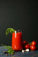 Glass of tasty tomato juice and fresh tomatoes