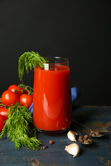 Glass of tasty tomato juice and fresh tomatoes