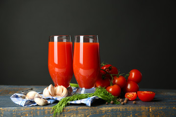 Glasses of tasty tomato juice and fresh tomatoes
