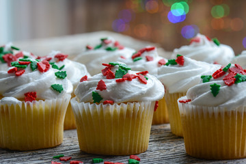 Christmas Cupcakes with Colorful Holiday Lights in Background