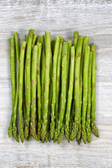 Pile of fresh Asparagus on Rustic white wood
