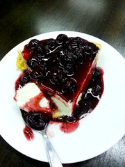 Blueberry cheese cakes in white plate on wooden table.