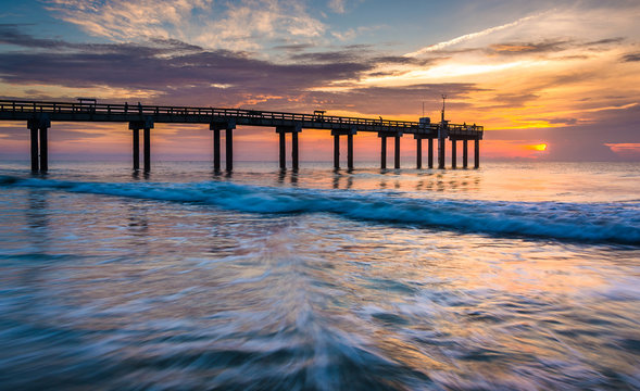 Waves on the Atlantic Ocean and fishing pier at sunrise, St. Aug