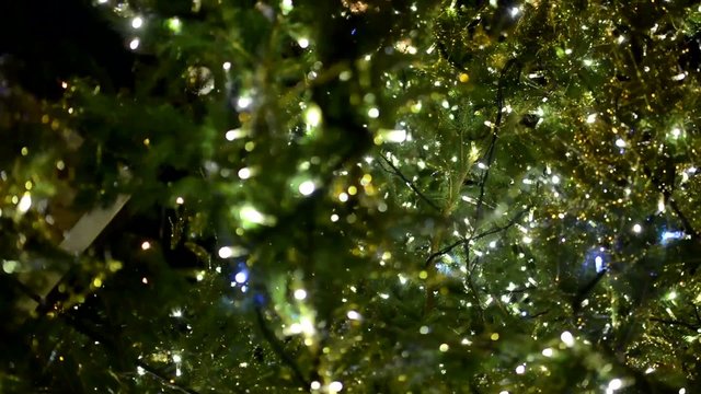 Christmas tree with christmas decorations and lights - night
