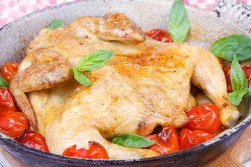 Roast chicken with tomatoes cherry, green basil and garlic