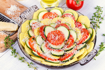Tomatoes, potatoes and zucchini prepared for bake