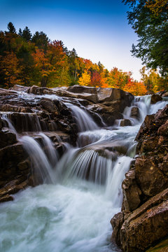 Autumn color and waterfall at Rocky Gorge, on the Kancamagus Hig © jonbilous