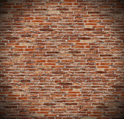 round circle spotlight on red brick wall, radial gradient shadow on old dark brown, orange brick fences or grungy rusty blocks of stone work