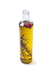 Bottle of olive oil with rosemary and pepper isolated on white