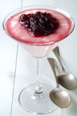 custard and cranberries in a glass