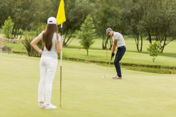 Young couple playing golf
