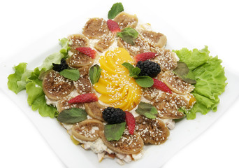 salad with a dessert of fruit and vegetables on the plate