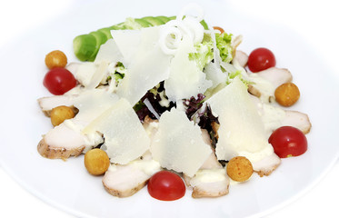 salad greens with meat and cheese on white background