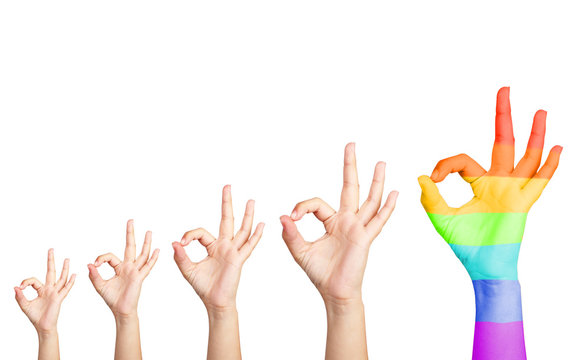 Man's hands isolated on white, one hand painted as rainbow flag