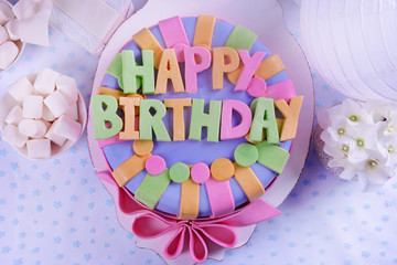 Delicious birthday cake on table close-up