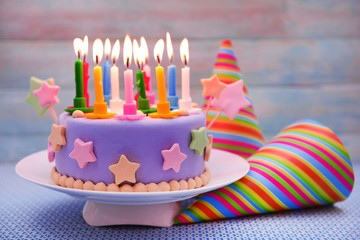 Delicious birthday cake on table on light background