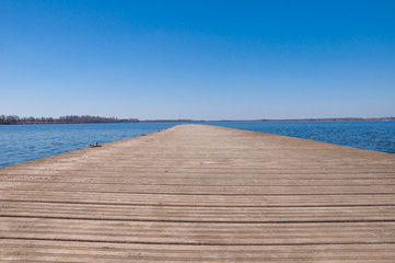 Fototapeta na wymiar Background of the wooden pier on the lake