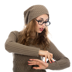 Young beautiful girl with glasses looking at his watch.