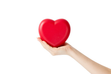 Red heart in woman hand, on white background close-up