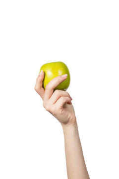 Woman's hand holding and showing a  green apple