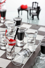 Chess board with shot glasses