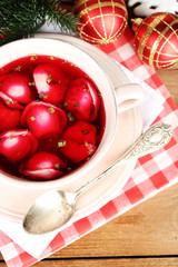 Traditional polish clear red borscht with dumplings and