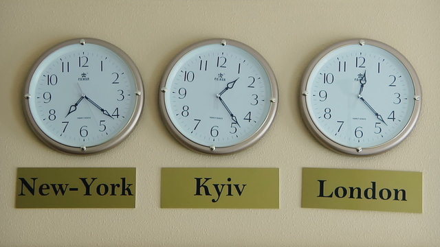 Three clocks showing the time zones of New York, London and Kyiv