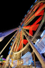 Fairground ferris wheel with colorful light trails