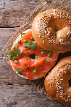 Traditional bagel with salmon and cream cheese top view vertical