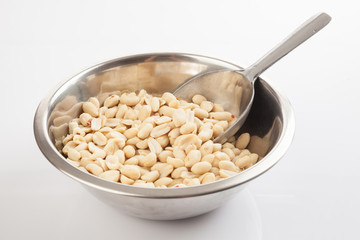 Peeled peanuts in bowl with transfer scoop