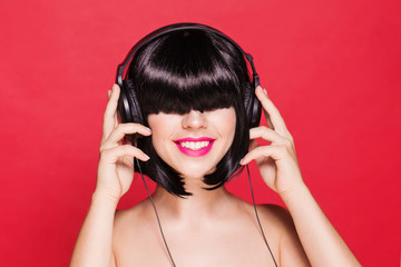 Woman listening to music on headphones enjoying a dance. Closeup