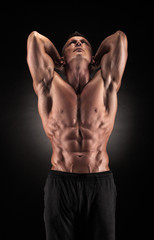 Fototapeta na wymiar Muscular man on black background