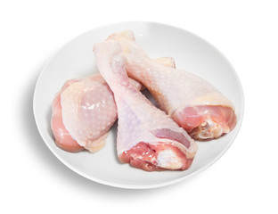 Three Raw Chicken Legs On White Plate