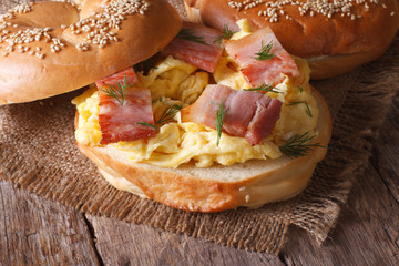 bagel with scrambled eggs and bacon close-up horizontal