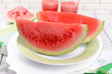 Juicy watermelon on table on brick wall background
