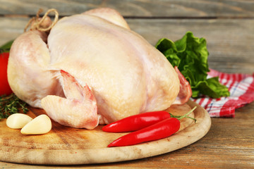 Raw chicken on wooden table