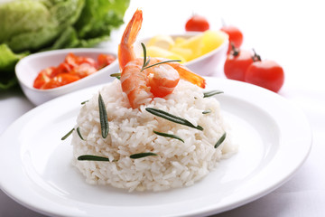 Boiled rice with shrimps served on table, close-up