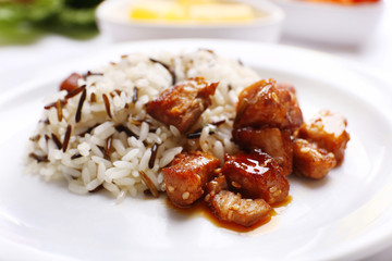 Tasty rice with meat served on table, close-up