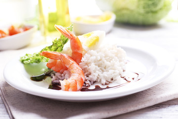 Boiled rice with shrimps served on table, close-up