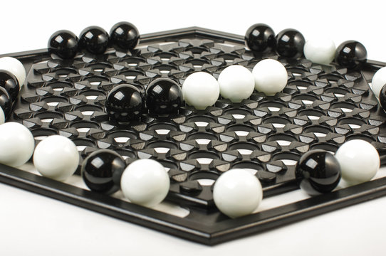 Racism concept black vs white on Abalone game board