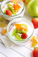 Healthy dessert with muesli and fruits on table