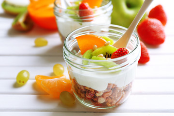 Healthy dessert with muesli and fruits on table