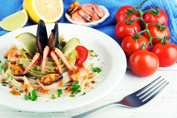 Tasty pasta with shrimps, mussels and tomatoes