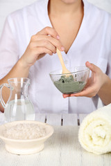 Beautician makes cosmetic facial masks, close-up