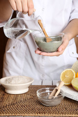 Beautician makes cosmetic facial masks, close-up,