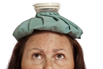 Woman’s Forehead With Ice pack For Headache