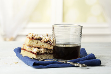 Glass of espresso and tasty homemade pie on wooden table