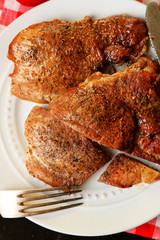 Roasted meat on plate, on wooden table background