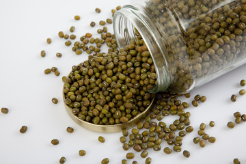 Mung beans in a jar on white  table with lid off